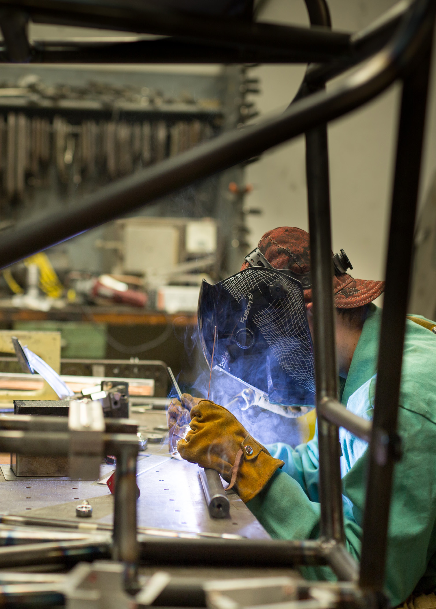 A student welding wearing a mask